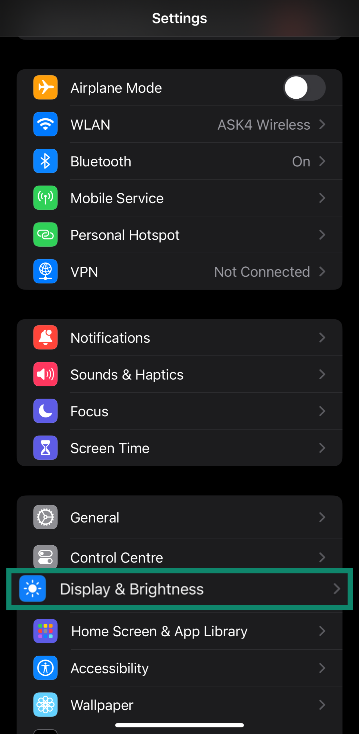 Accessing the Display & Brightness settings through an iPhone's settings menu