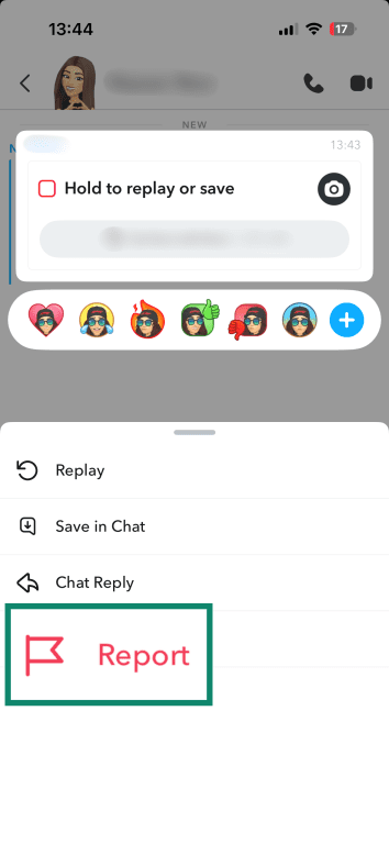 Snapchat chat options menu displaying “Hold to replay or save” with reaction emojis and report option highlighted